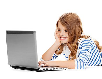 education, technology and internet concept - smiling little student girl with laptop computer lying on the floor