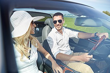 leisure, road trip, dating, couple and people concept - happy man and woman driving in cabriolet car outdoors