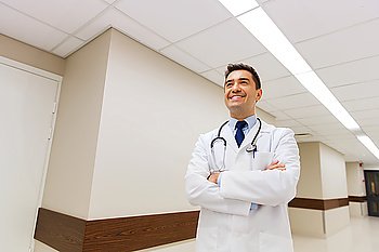 healthcare, profession, people and medicine concept - smiling male doctor in white coat with stethoscope at hospital