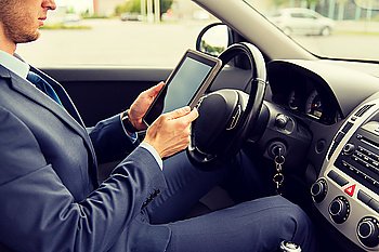transport, business trip, technology and people concept -close up of young man with tablet pc computer driving car