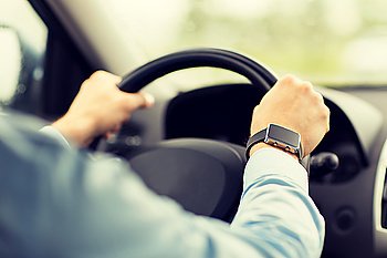 transport, business trip, technology, time and people concept - close up of man with wristwatch driving car