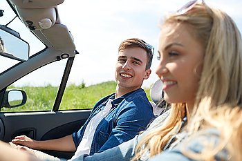 leisure, road trip, travel and people concept - happy couple driving in cabriolet car outdoors