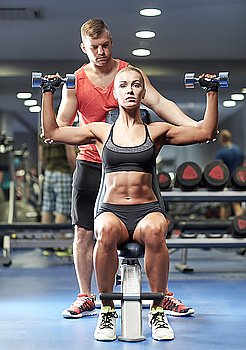 sport, fitness, bodybuilding, lifestyle and people concept - man and woman with dumbbells flexing muscles in gym