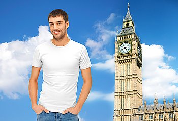 travel, tourism and people concept - handsome man in blank white t-shirt over big ben clock tower and blue sky background