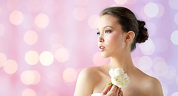 beauty, jewelry, people and luxury concept - beautiful asian woman or bride in white dress with peony flower and golden ring over holidays lights background