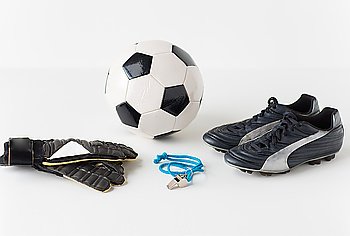 sport, soccer and sports equipment concept - close up of ball, whistle, goalkeeper gloves and football boots