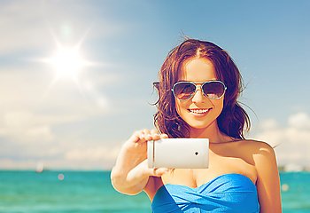 close up of beautiful woman on the beach with phone. woman in bikini with phone