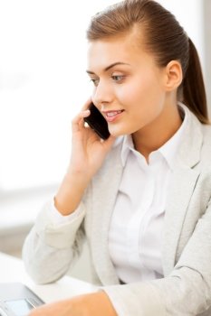 picture of smiling businesswoman with smartphone in office