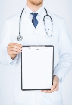 close up of doctor holding blank white paper