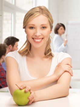 picture of beautiful girl with green apple at school