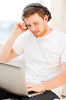 happy man with headphones listening to music at home