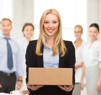 attractive businesswoman delivering cardboard box in office
