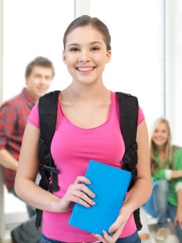 education concept - smiling student girl with book and school bag