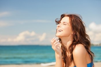 bright picture of laughing woman on the beach.