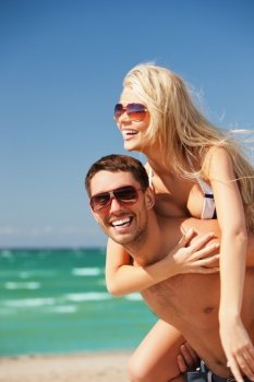 picture of happy couple in sunglasses on the beach (focus on man).