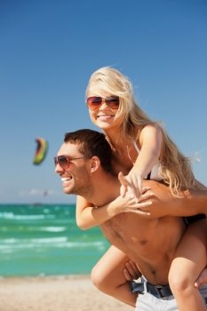 picture of happy couple in sunglasses on the beach. (focus on woman)