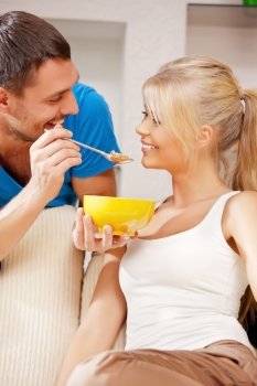 bright picture of happy couple with muesli (focus on man)