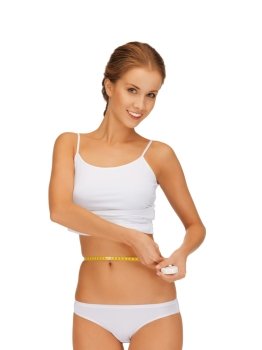 picture of young beautiful woman measuring her waist
