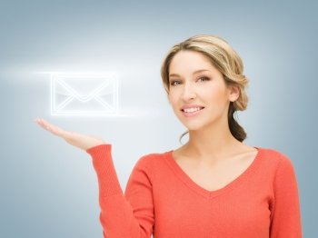 smiling woman showing virtual envelope on the palm of her hand