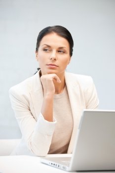 picture of pensive woman with laptop computer