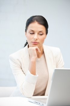 picture of pensive woman with laptop computer.