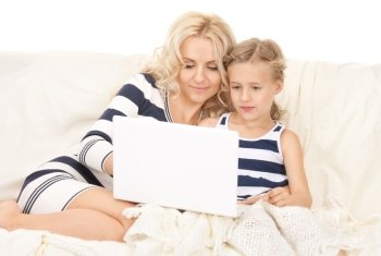 bright picture of happy mother and child with laptop computer
