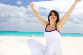 happy woman with white sarong on the beach