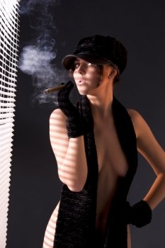 sexy woman in black astrakhan smoking cigar