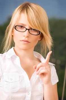 bright picture of young woman making warning gesture