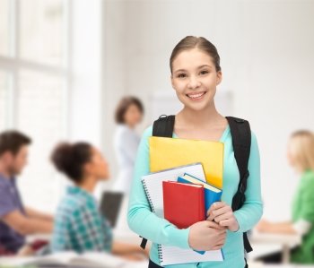 education and school concept - happy and smiling teenage girl with backpack and books