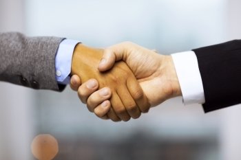 business and office concept - businessman and businesswoman showing shaking hands in office