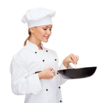 cooking and food concept - smiling female chef, cook or baker with pan and spoon