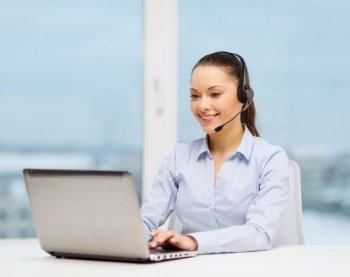 business, communication and call center concept - friendly female helpline operator with headphones and laptop computer