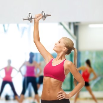 diet and fitness concept - young sporty woman lifting steel dumbbell