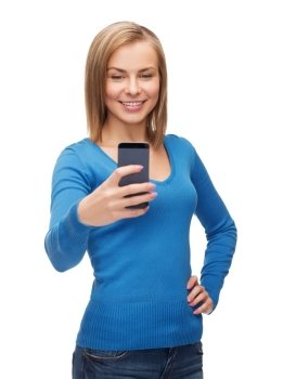 techniology and internet concept - smiling woman taking self picture with smartphone camera