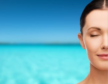 health, spa and beauty concept - clean face of beautiful young woman with closed eyes