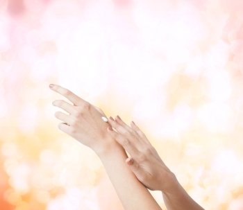 body parts, cosmetics and spa concept - close up of female soft skin hands with creme