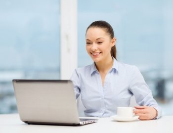 office, business and technology concept - smiling businesswoman or student with laptop computer and coffee in office
