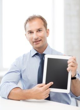 picture of smiling businessman with tablet pc in office