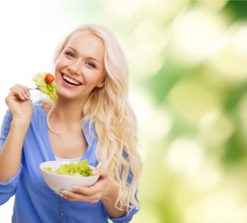 healt, dieting and happiness concept - smiling young woman with green salad