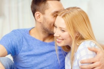 love, family and happiness concept - man kissing young woman at home