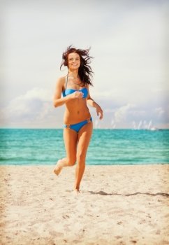 picture of happy smiling woman jogging on the beach