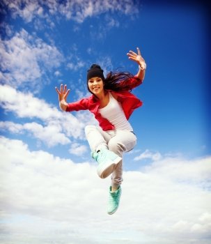 sport, dancing and urban culture concept - beautiful dancing girl jumping