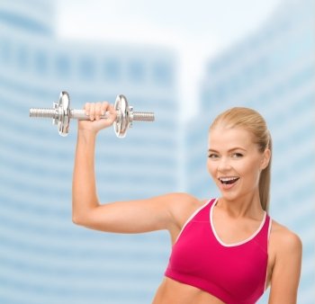 fintess, healthcare and dieting concept - young sporty woman with heavy steel dumbbell