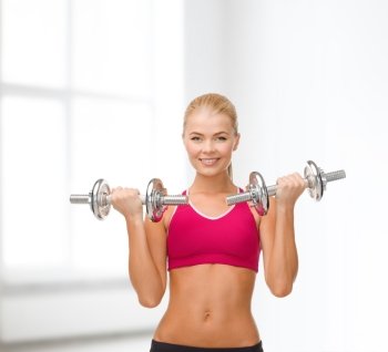 fitness, healthcare and dieting concept - young sporty woman lifting steel dumbbells