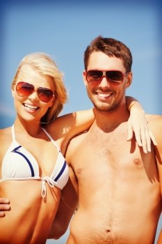 picture of happy couple in sunglasses on the beach
 (focus on man)