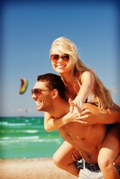 picture of happy couple in sunglasses on the beach
 (focus on woman)