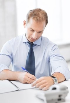 business concept - handsome businessman working in the office