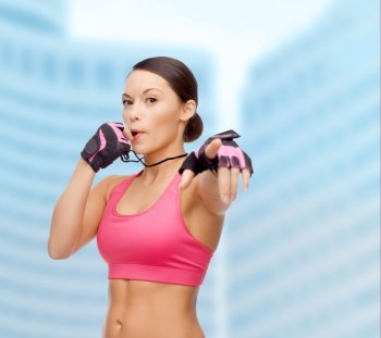 sport, fitness and healthcare concept - beautiful asian personal trainer with whistle