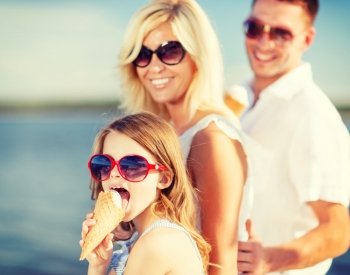 summer holidays, celebration, children and people concept - happy family eating ice cream